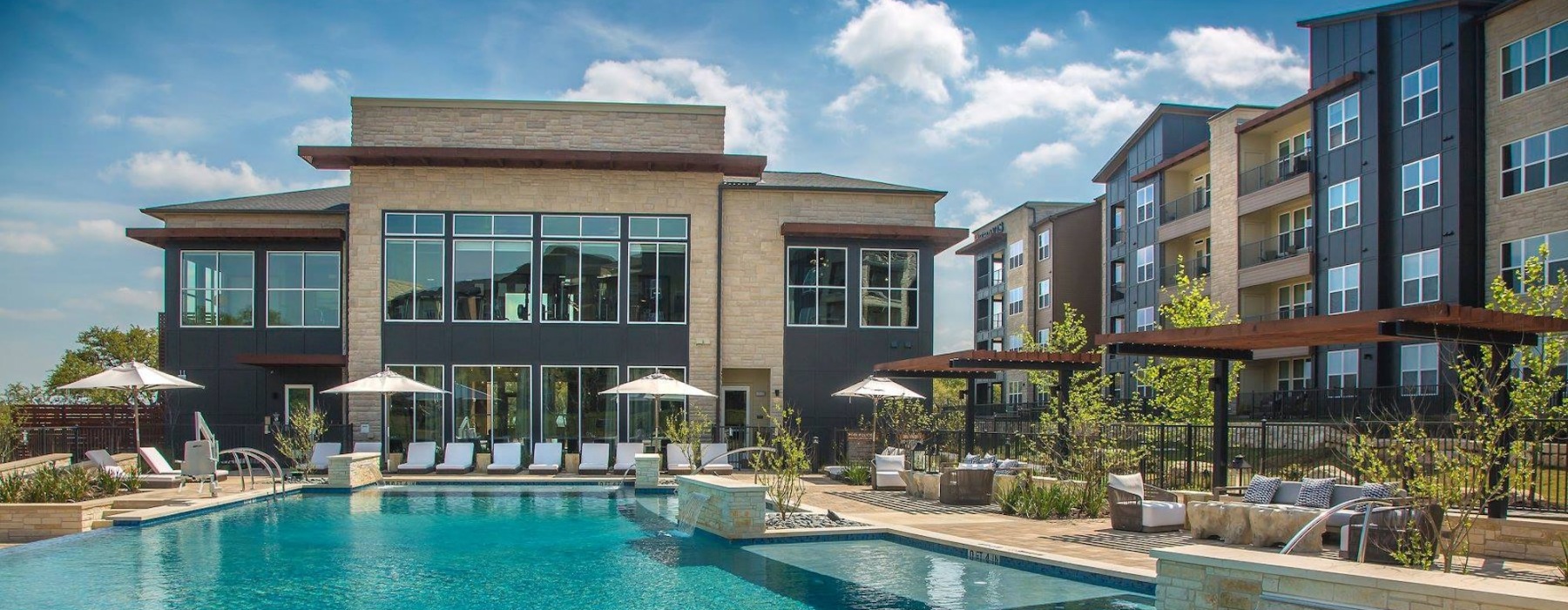 Resort-style swimming pool with lounge seating