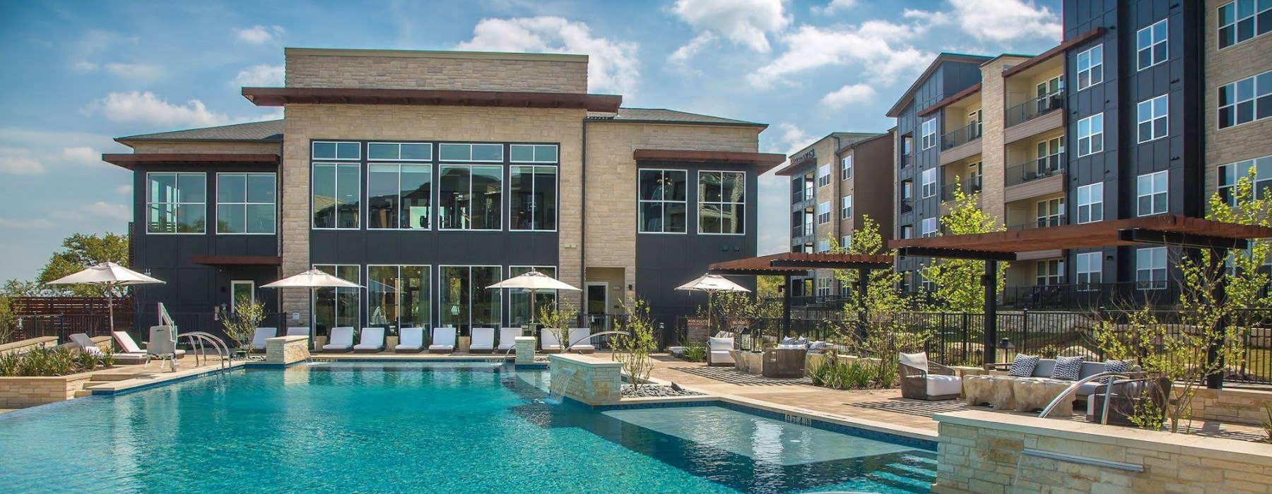 Resort-style swimming pool with lounge seating